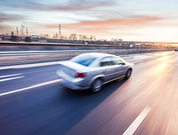 um carro a conduzir numa auto-estrada a alta velocidade